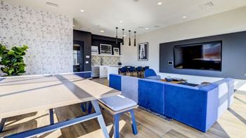 a blue and white living room with a table and a television